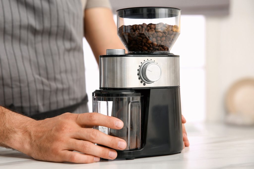 Using compact electric coffee grinder Using compact electric coffee grinder