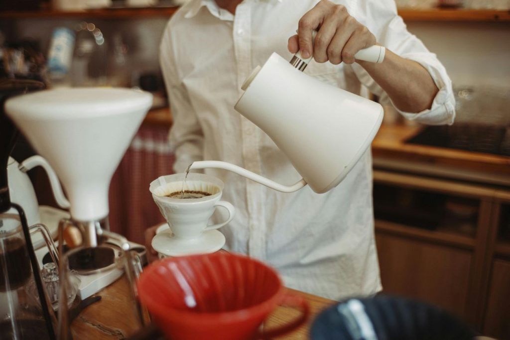 essential pour-over coffee equipment including burr grinder gooseneck kettle and scale